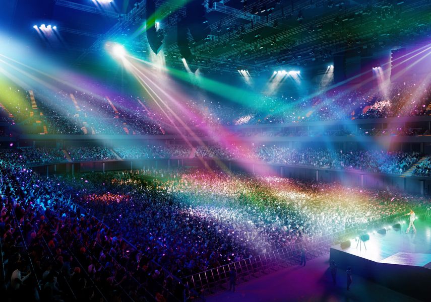 The Co-op Live bowl with rainbow coloured lighting across the full capacity crowd, with a performer on stage